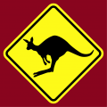 road sign kangaroo crossing, with a kangaroo in the middle of a jump.