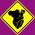 Stylized Koala designed from the front and pasted on a road sign.